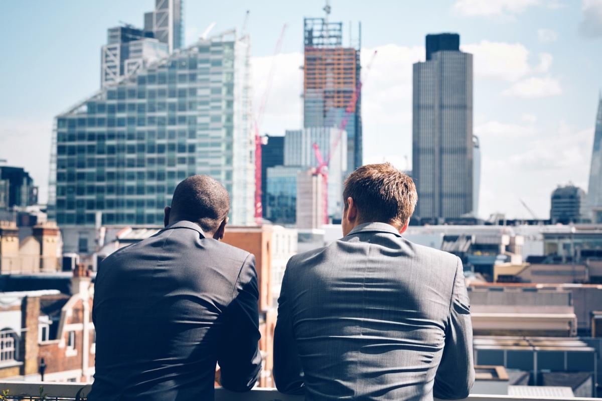 Two businessmen looking at skyline