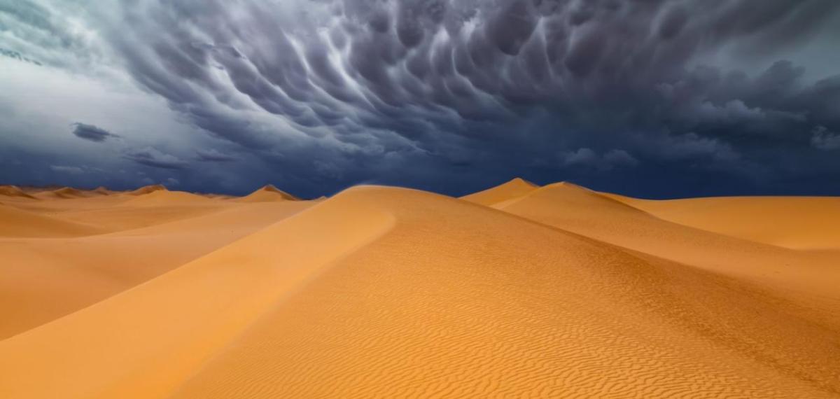 Illustration of a storm over a desert.