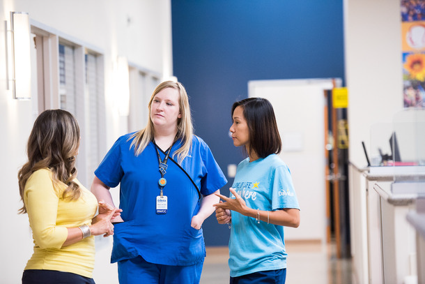 A healthcare worker talking with patients