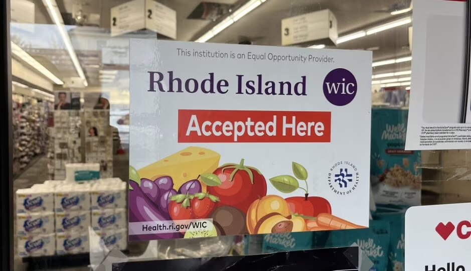 Sign reading "Rhode Island WIC Accepted Here" on a window