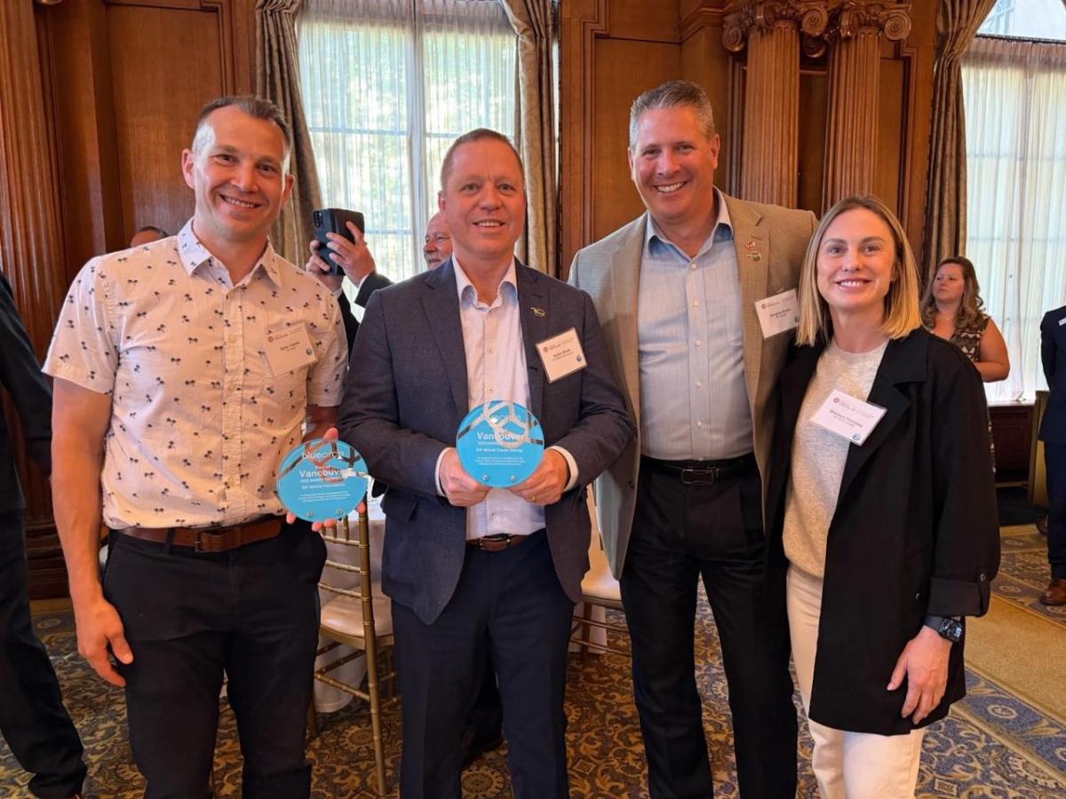 DP World recipients standing with their blue circle award 