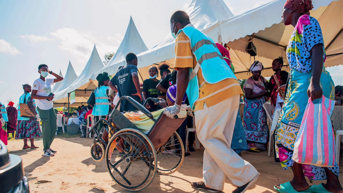 healthcare worker wheeling a patient