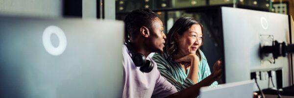 two people looking at a computer