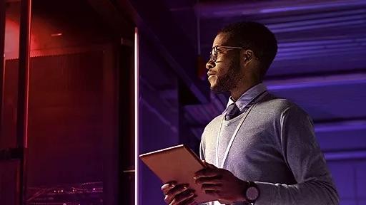 person holding a tablet in a dark room