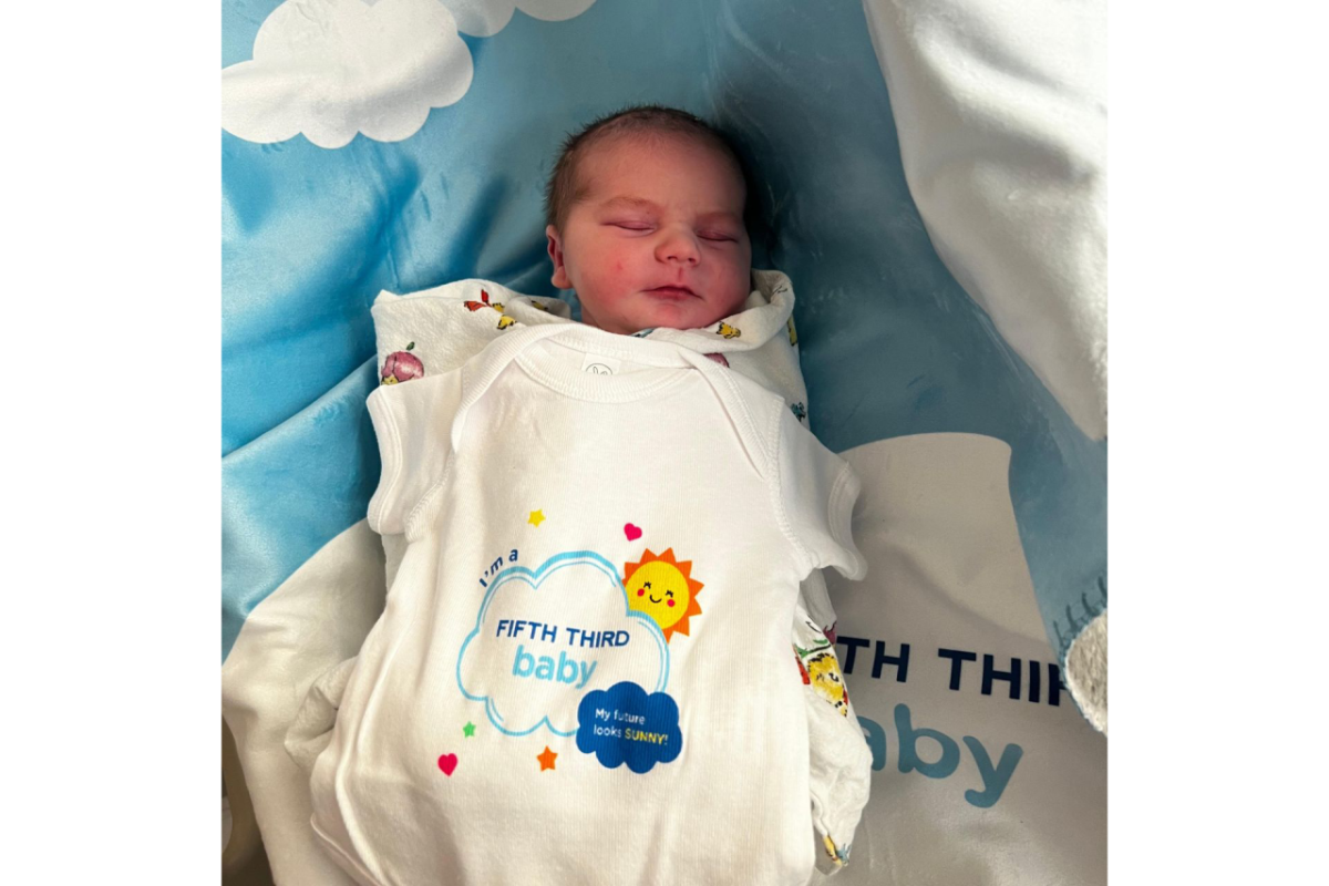 baby in an "I'm a Fifth Third Baby" onsie
