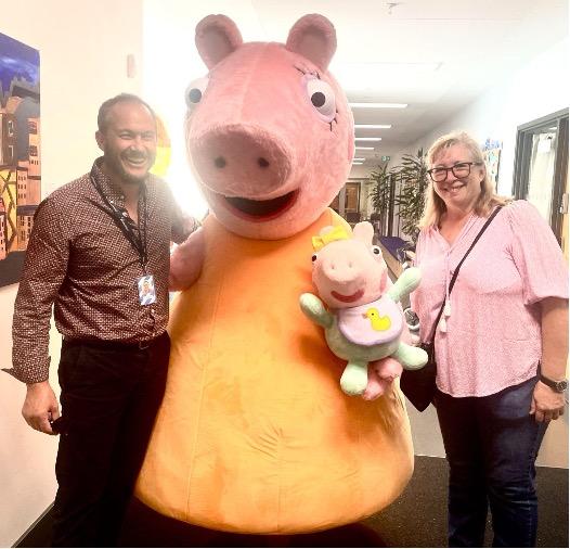 people posing with mascot