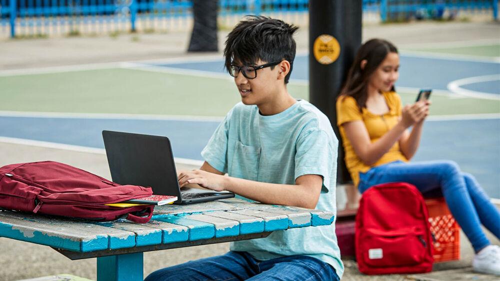 student works on a laptop