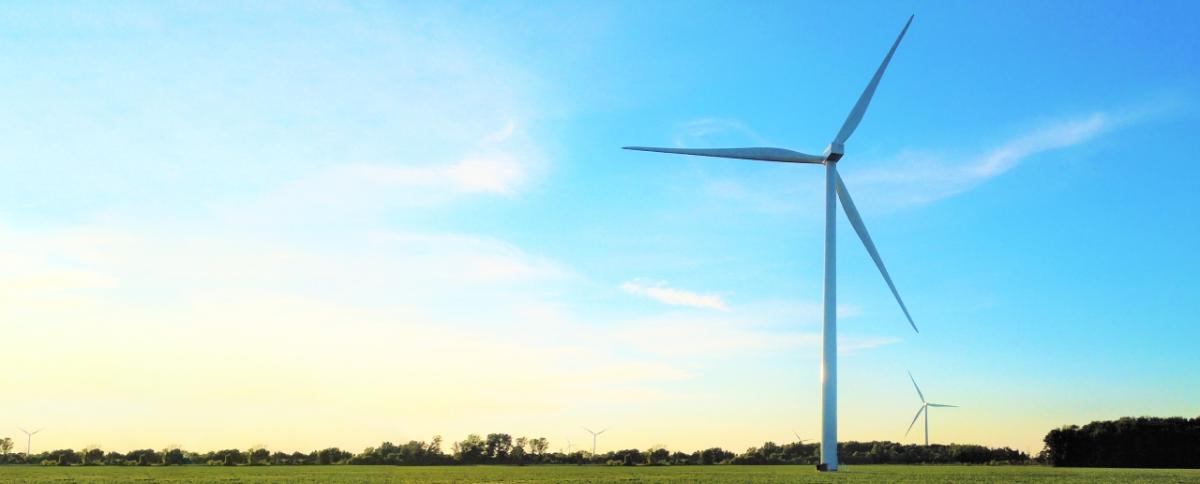 wind turbines at dawn on an open field