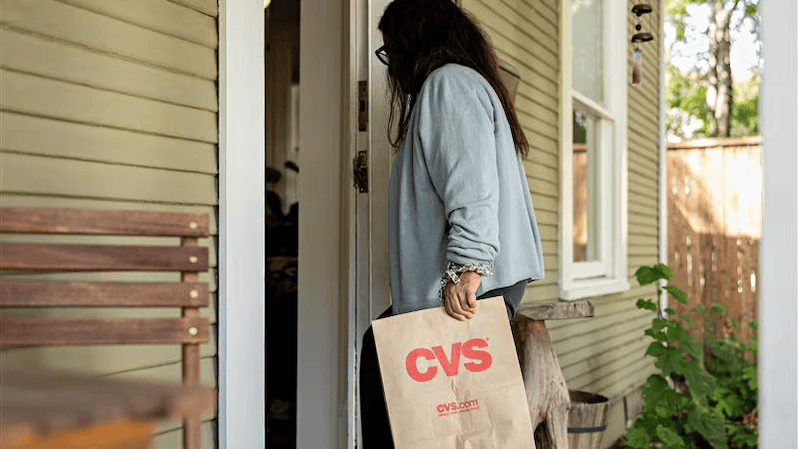 A CVS Health delivery being made to a doorstep.
