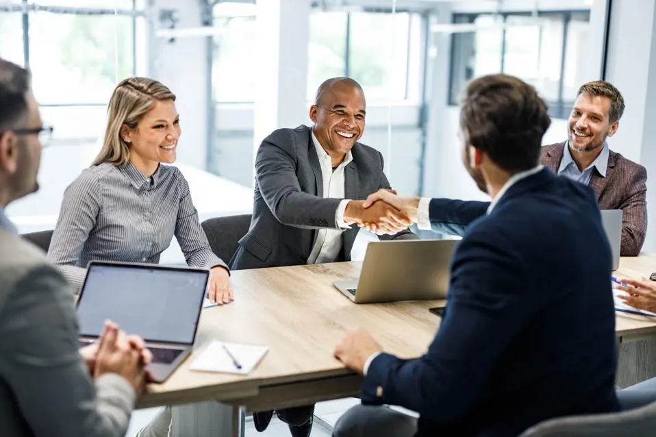 People shaking hands in a meeting