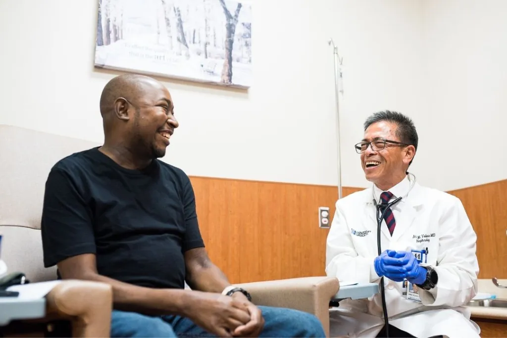 Healthcare worker laughing with a patient