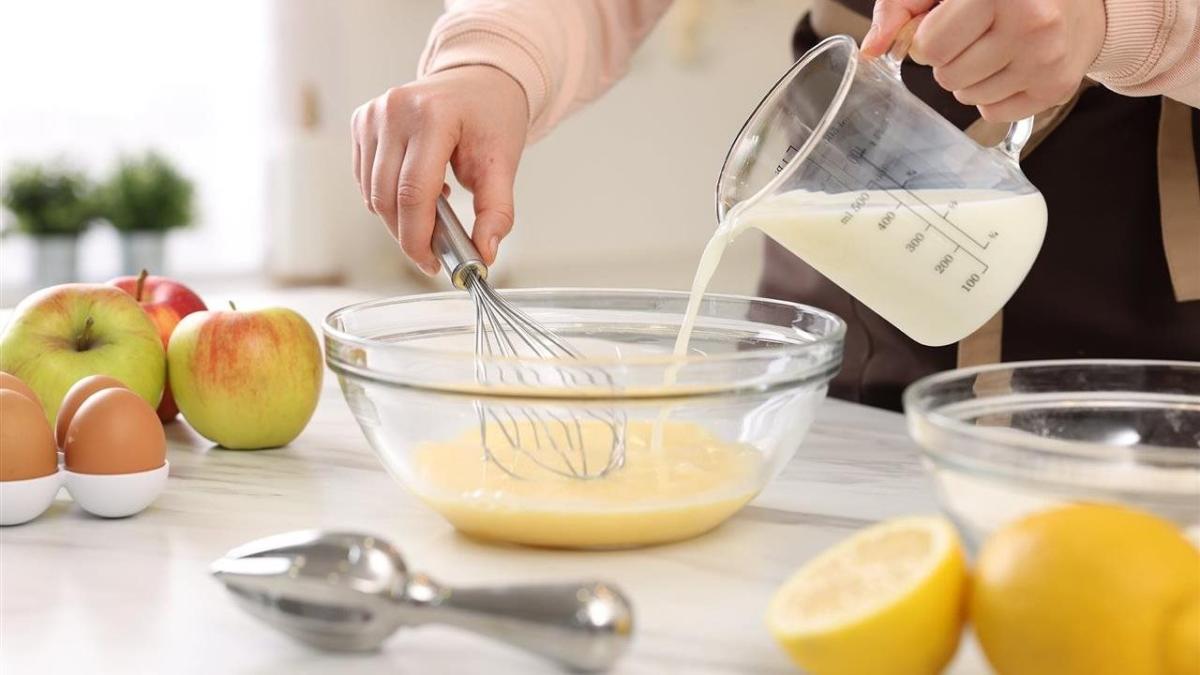 milk being whisked into eggs
