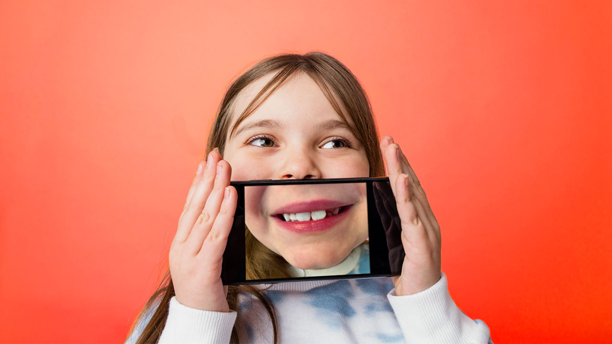 Child holding up cellphone