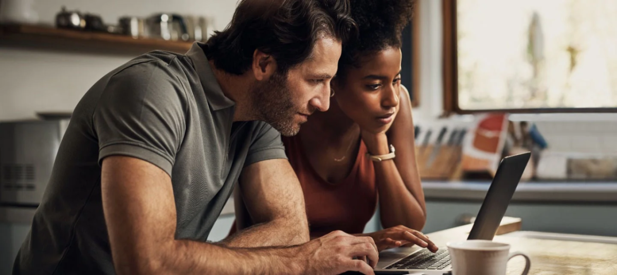 Two people looking at a laptop together