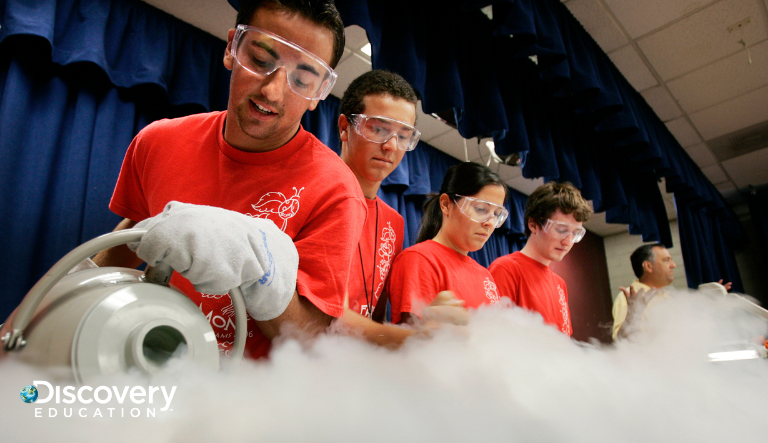 Students in safety glasses working on a project