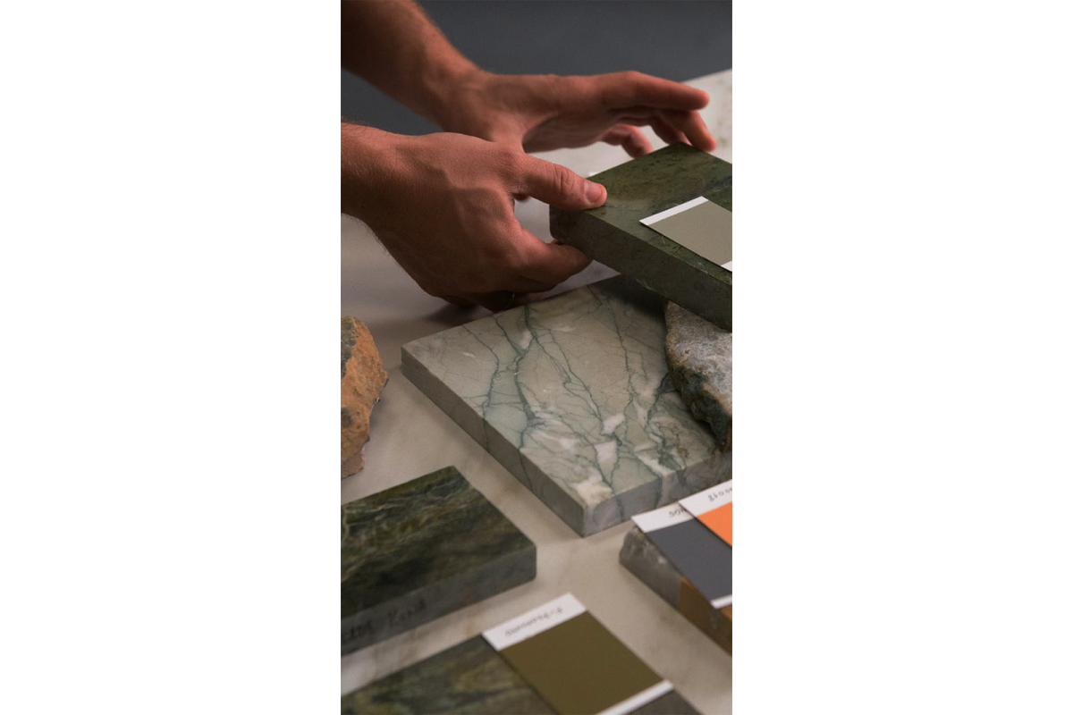 comparing paint swatches with marble material
