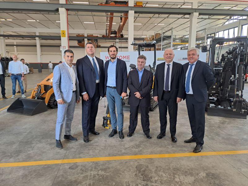 6 people standing together in a factory