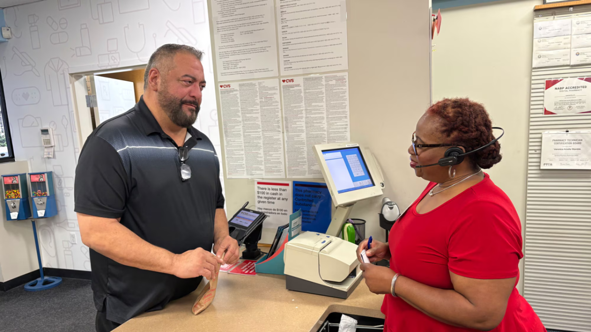 A patient speaking with someone over a counter