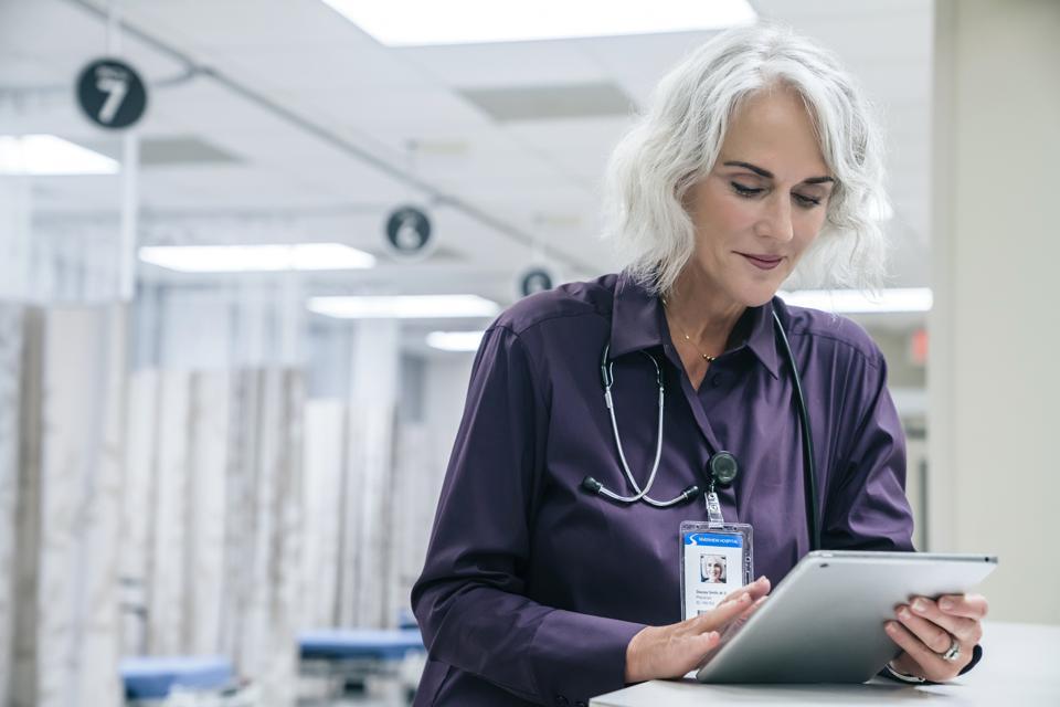 Doctor reading a tablet