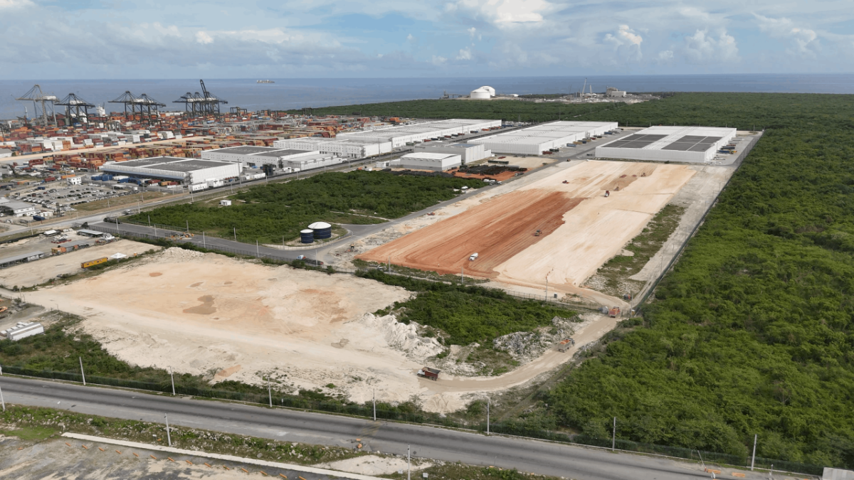 Aerial view of the Port of Caucedo and existing economic zone in the background, with cleared land in the foreground marking the site of DP World’s planned expansion.