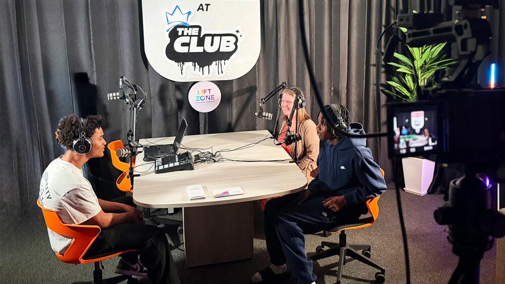 Three people talking with microphones and recording equipment