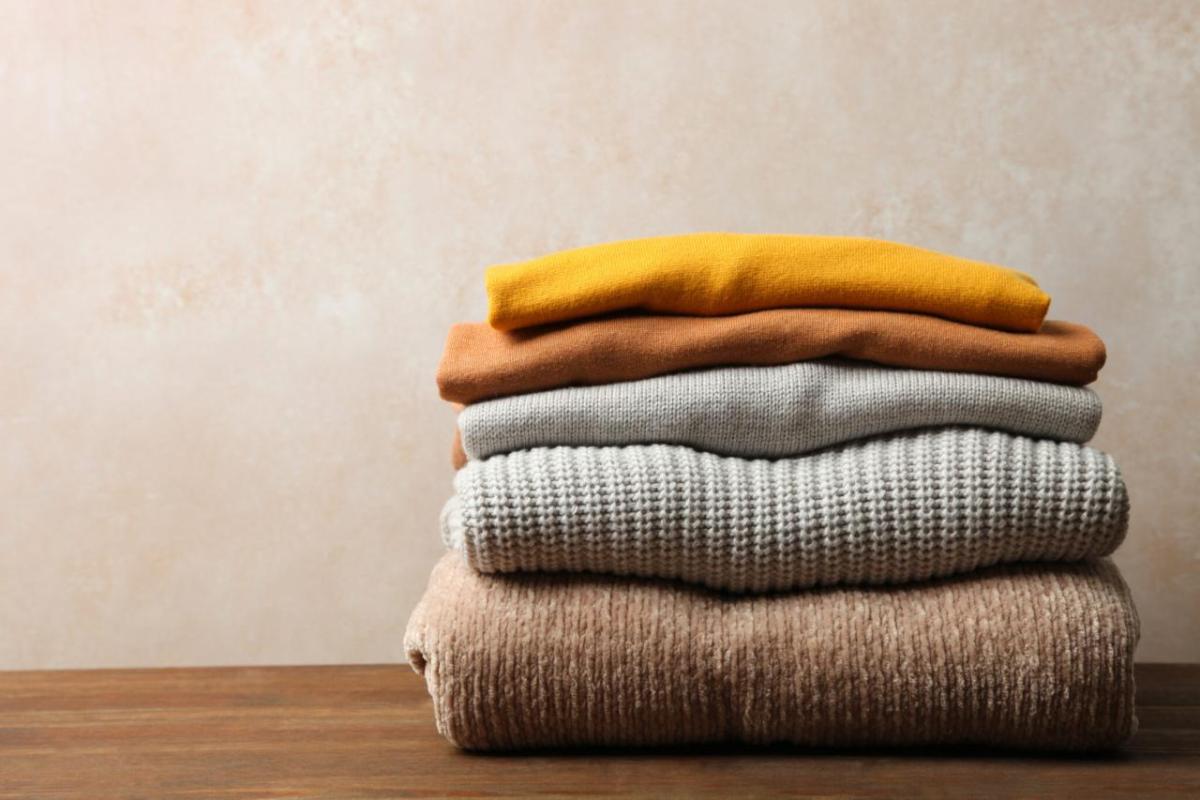 folded sweaters on a table