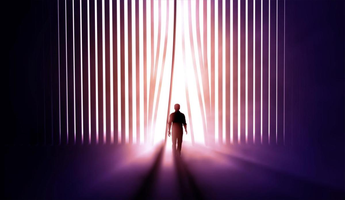 person walking into light