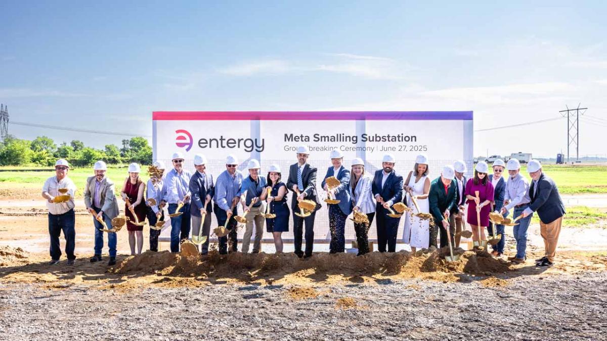 Group of people in hard hats with ceremonial shovels of dirt