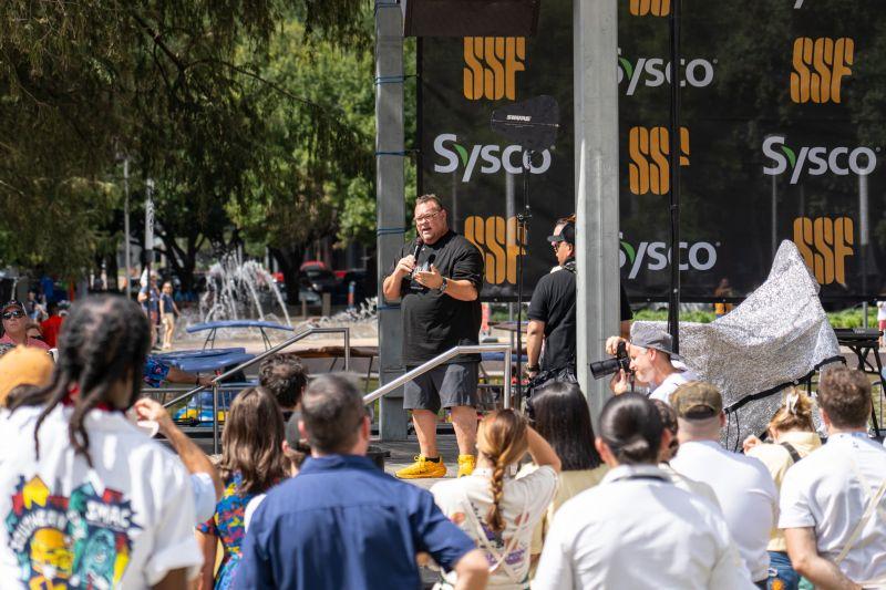person speaking at outdoor event