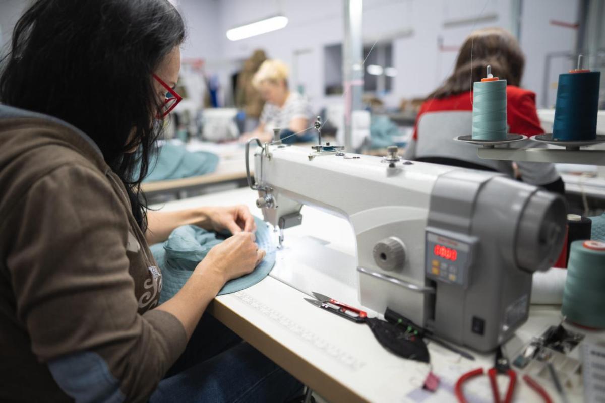 apparel factory worker at sewing machine