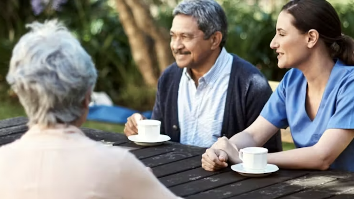 Three people drinking tea or coffee together