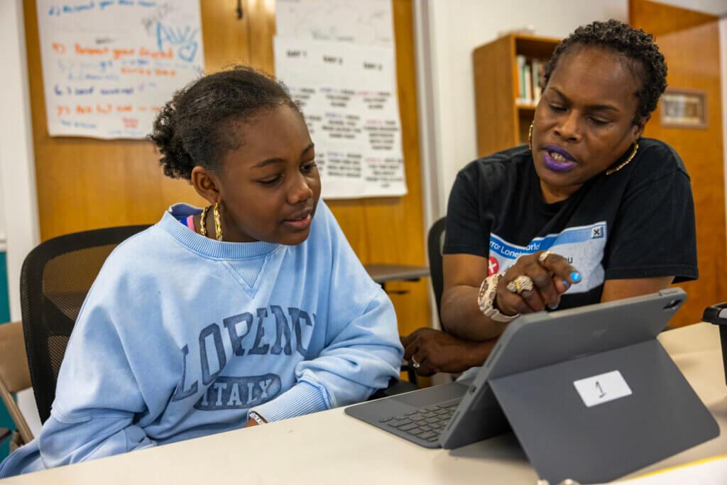A teacher working with a student