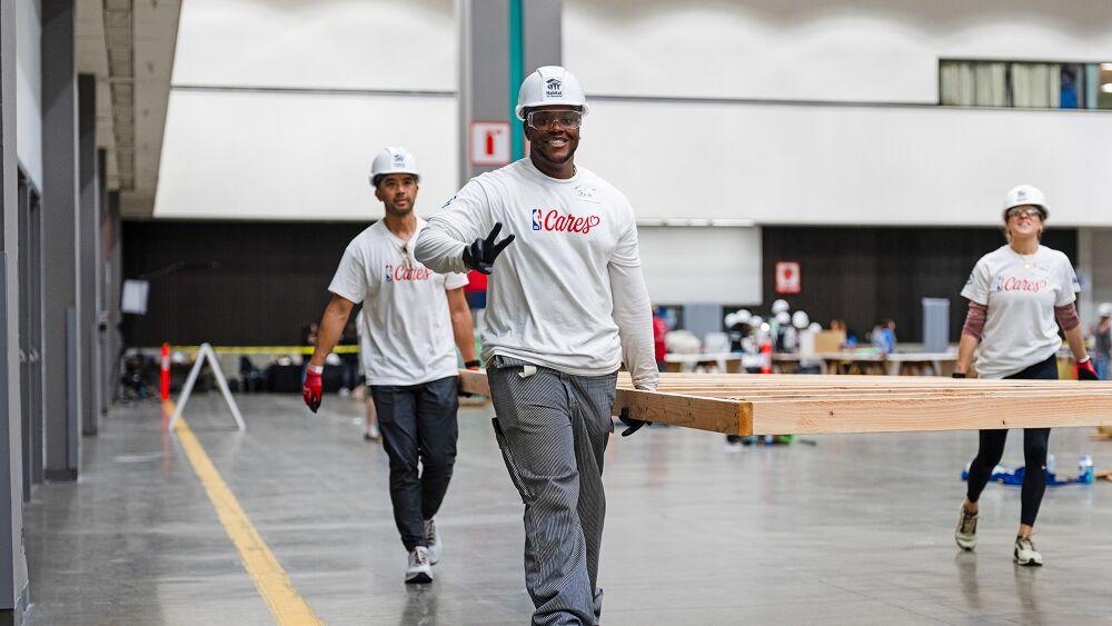 volunteers carrying things and smiling