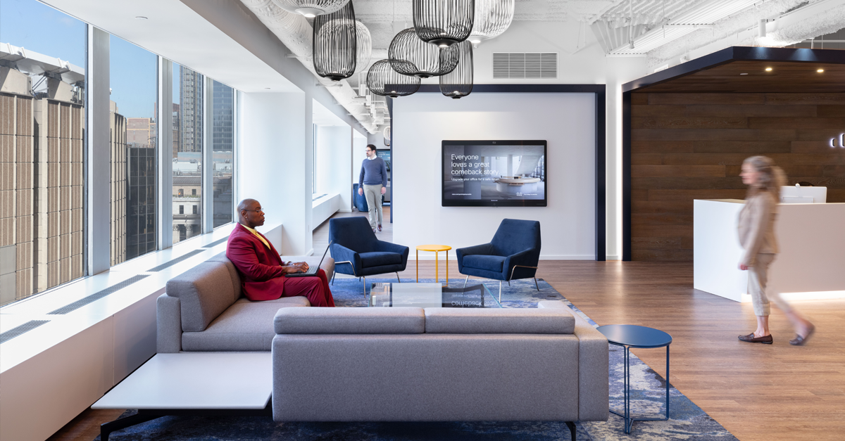 People inside office space with chairs and couches