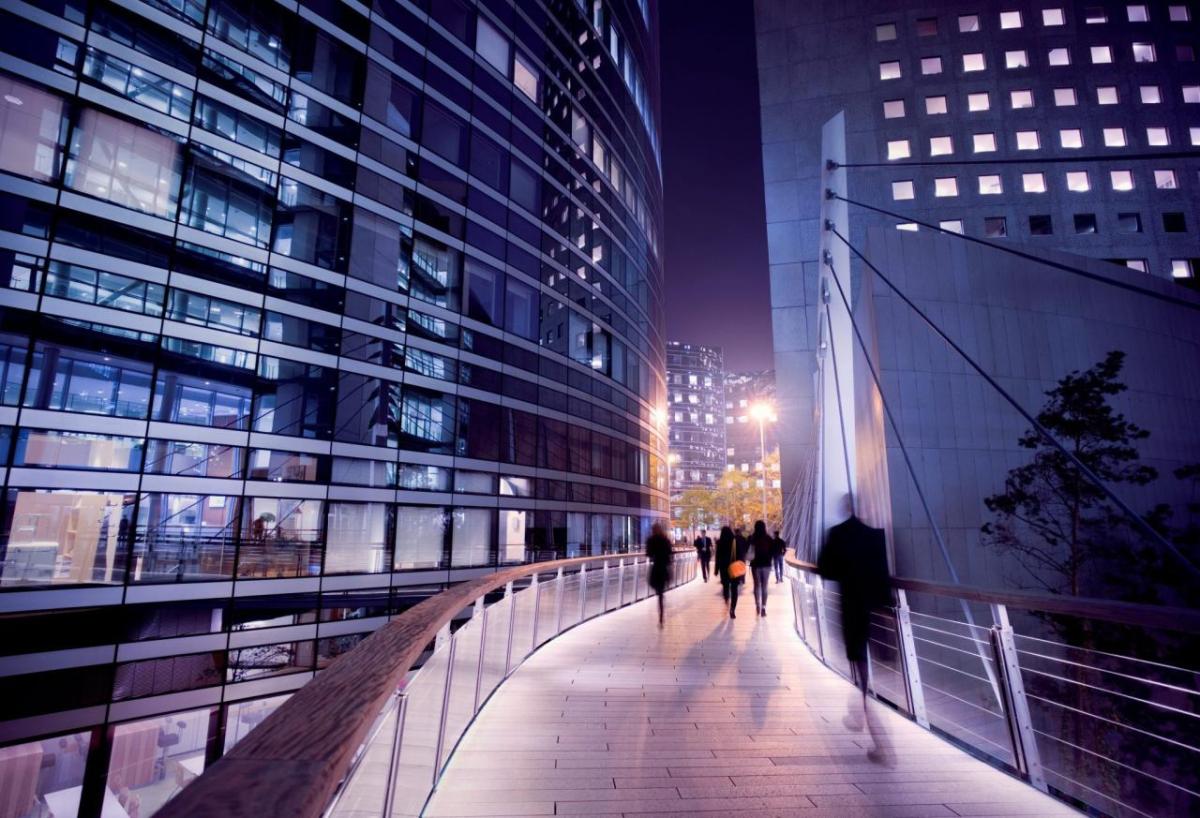 People walking in city at night