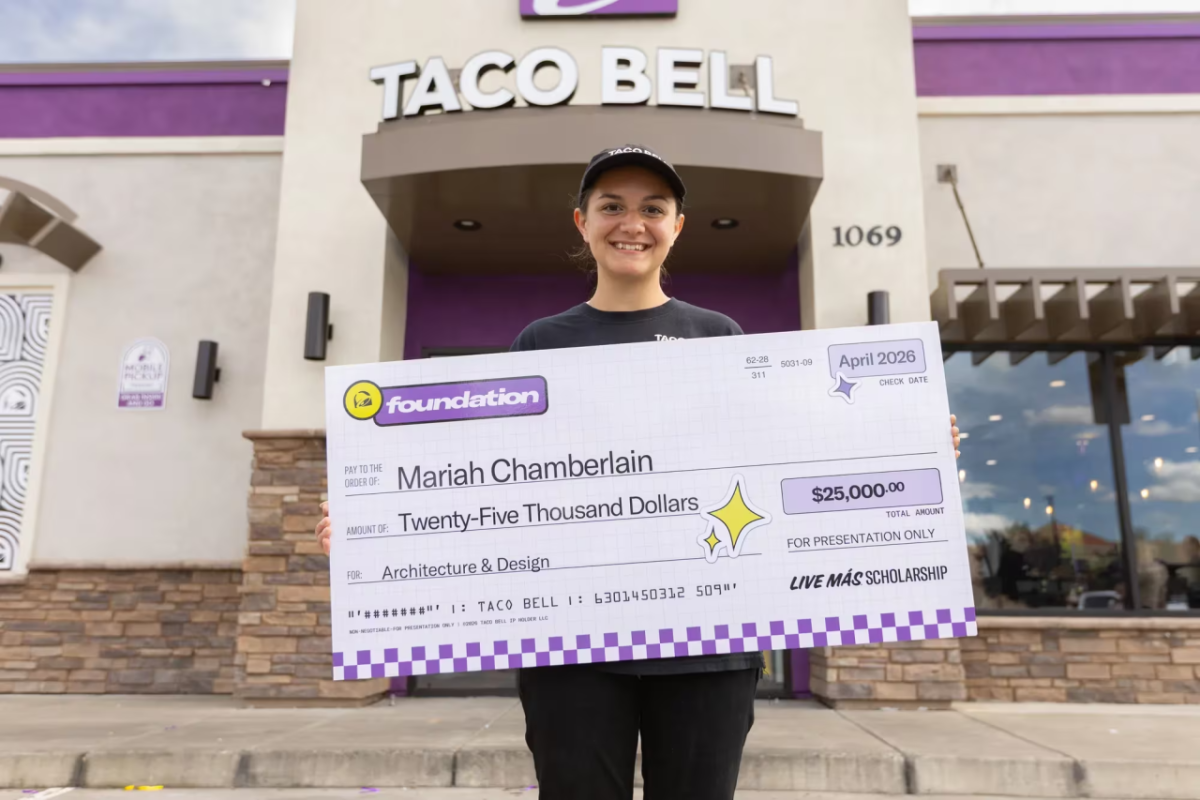 Mariah Chamberlain holding an oversized check