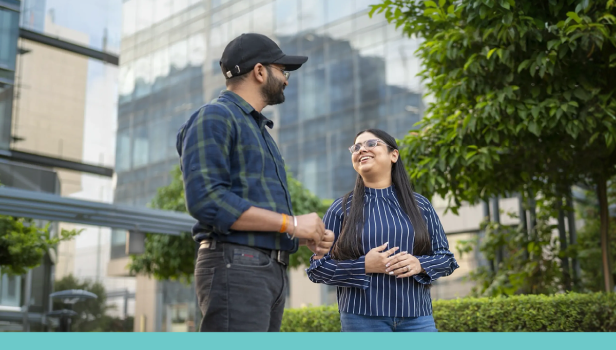 Two workers speaking outside an office building