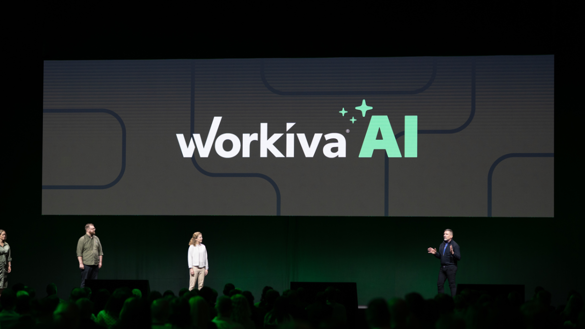 People on a stage with "Workiva AI" behind them
