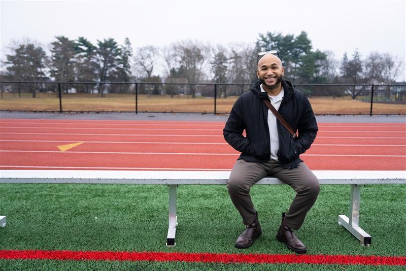 person sitting on a bench at a track