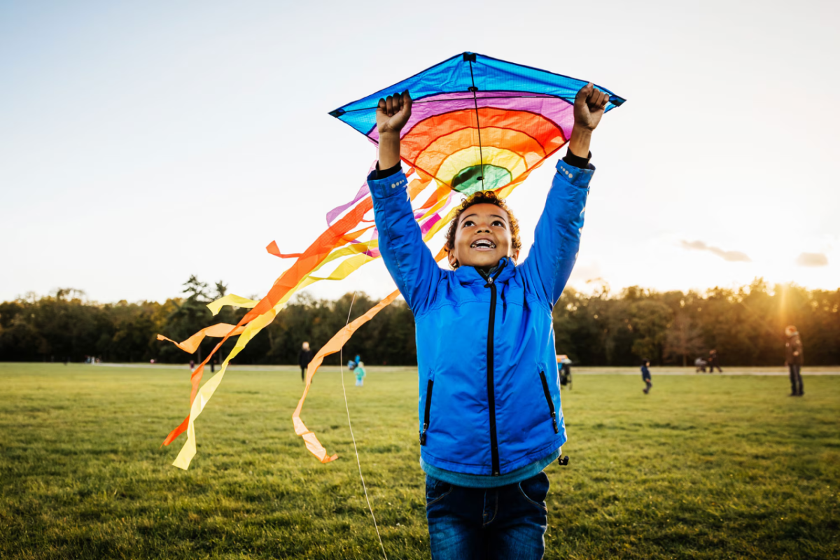 A child holding a colorful kite