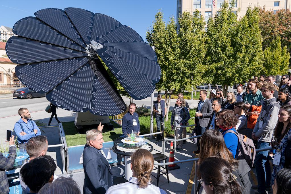 People stood looking at the SmartFlower Solar