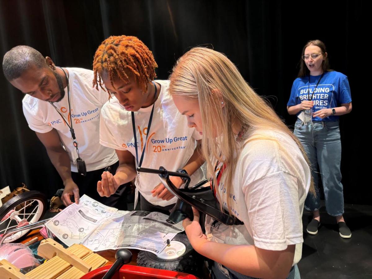 Interns and volunteers working together to assemble bikes and wagons.