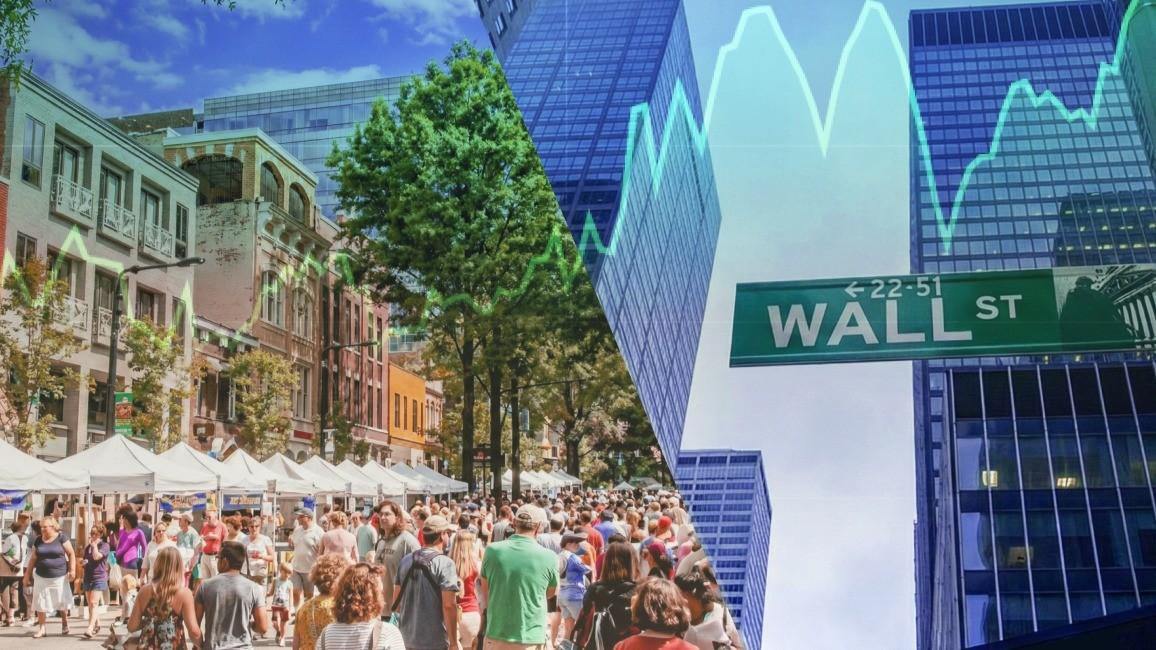 people walking down Wall St.