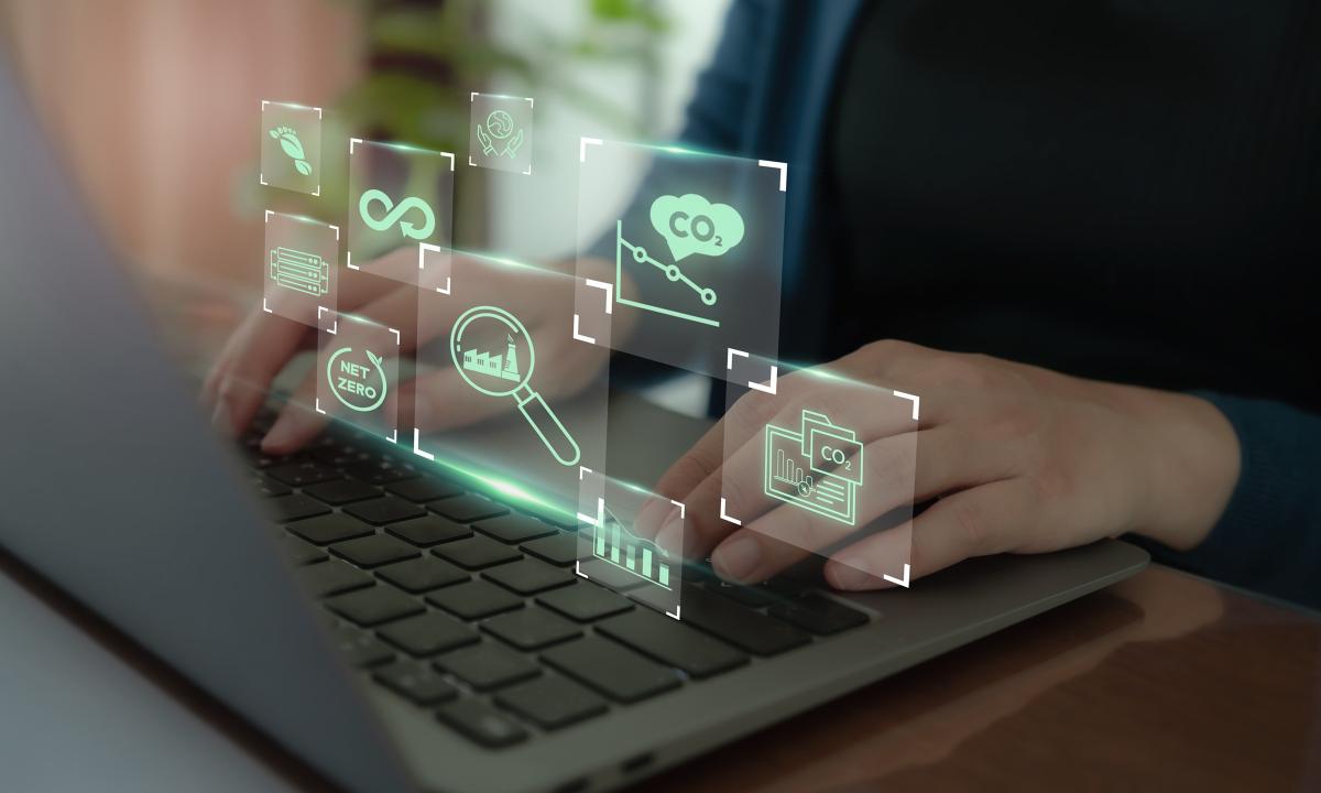 Using a laptop with digital icons representing digital tools used environmental monitoring.
