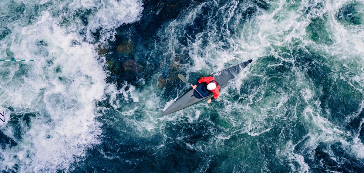 Kayak shown in rough waters.