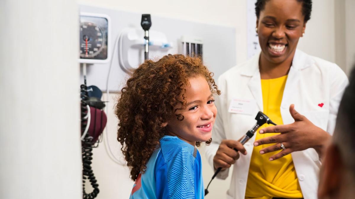 A young girl being examined by a doctor.