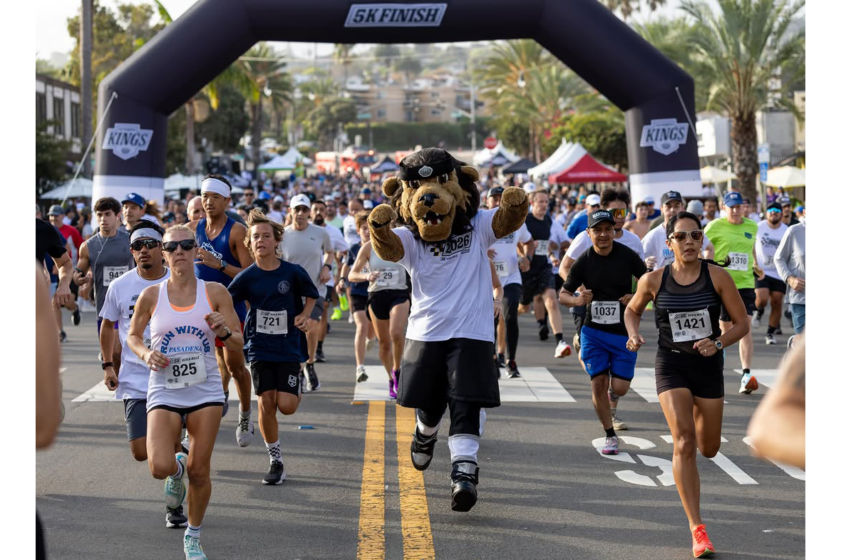 LA Kings Mascot Bailey running with arms pumped up aside runners