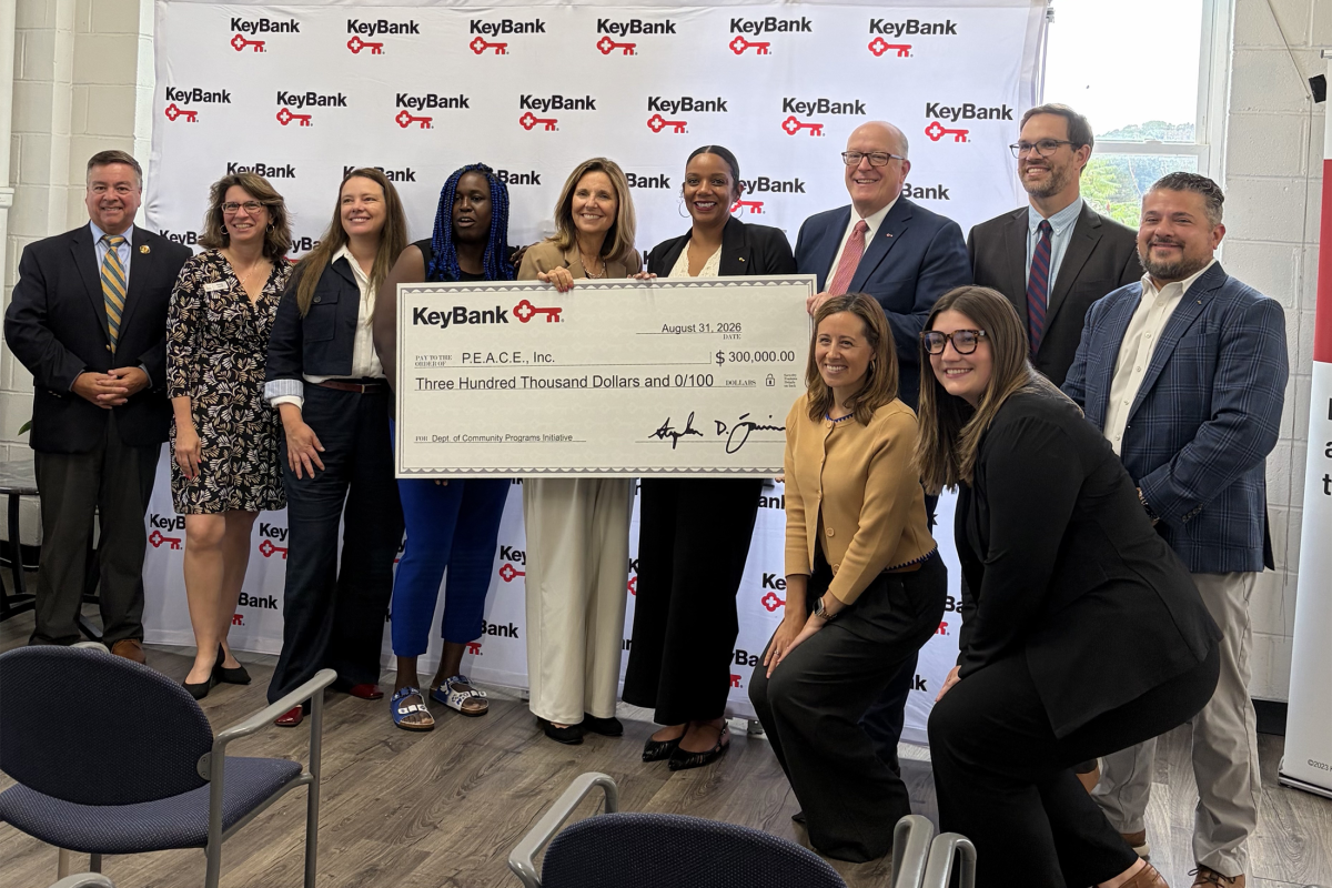 Group posing with an oversized check