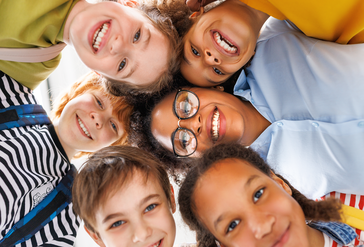 Children gathered together and smiling at the camera