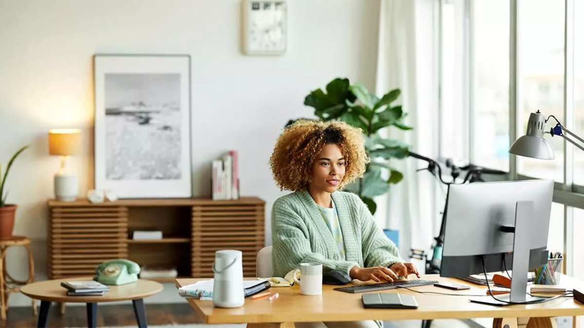 A young person typing in a home office
